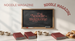 NoodleMagazine written in elegant red lettering on a blackboard